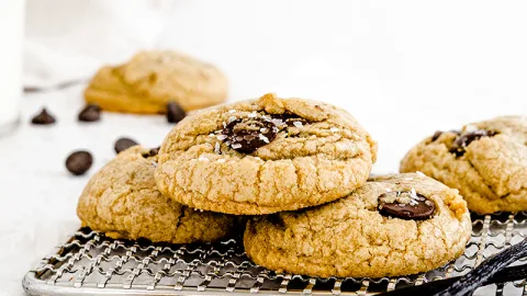 Chocolate Chip Cookies on a small cookie rack with a white background.