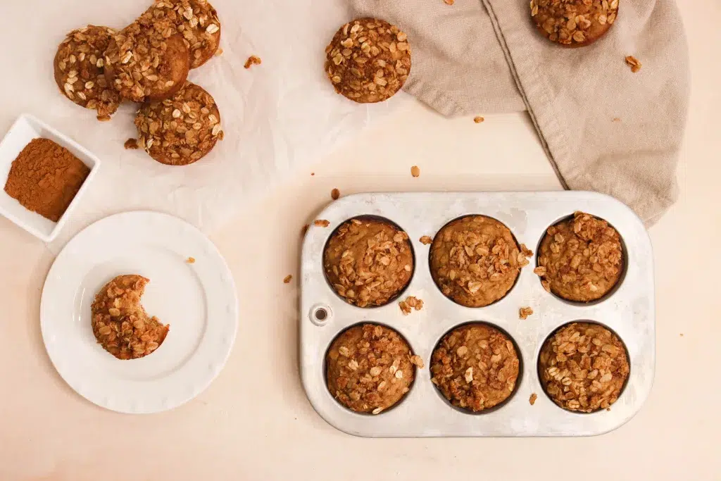 Oatmeal applesauce muffins on a neutral background