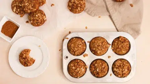 Oatmeal applesauce muffins on a neutral background