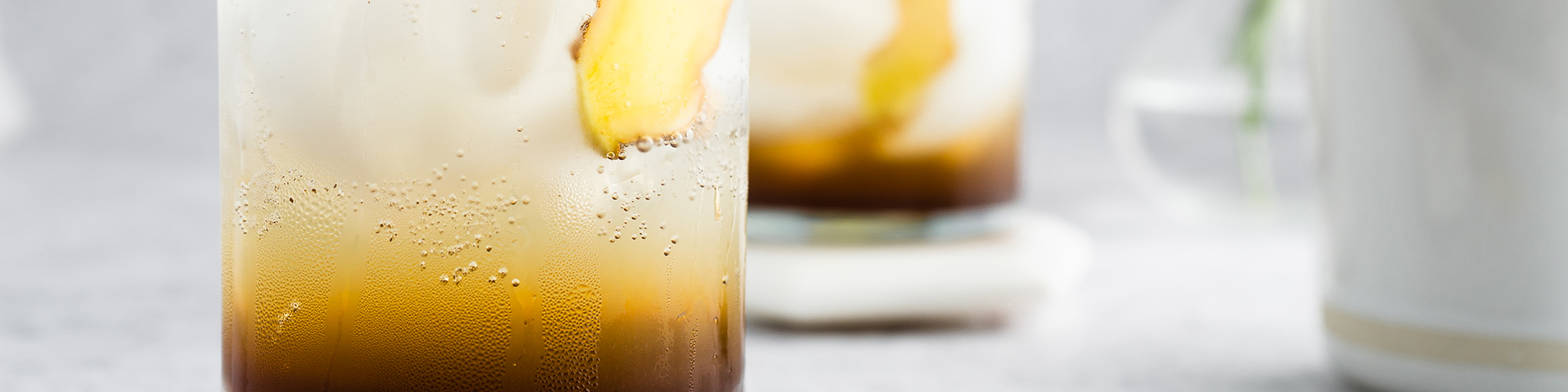 glasses of vanilla ginger sparklies drinks on coasters and neutral background