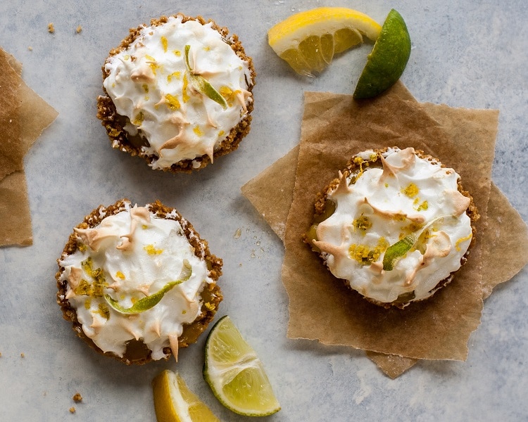 Finished product of the lemon lime tartlets on nice background with slices of lemon and lime