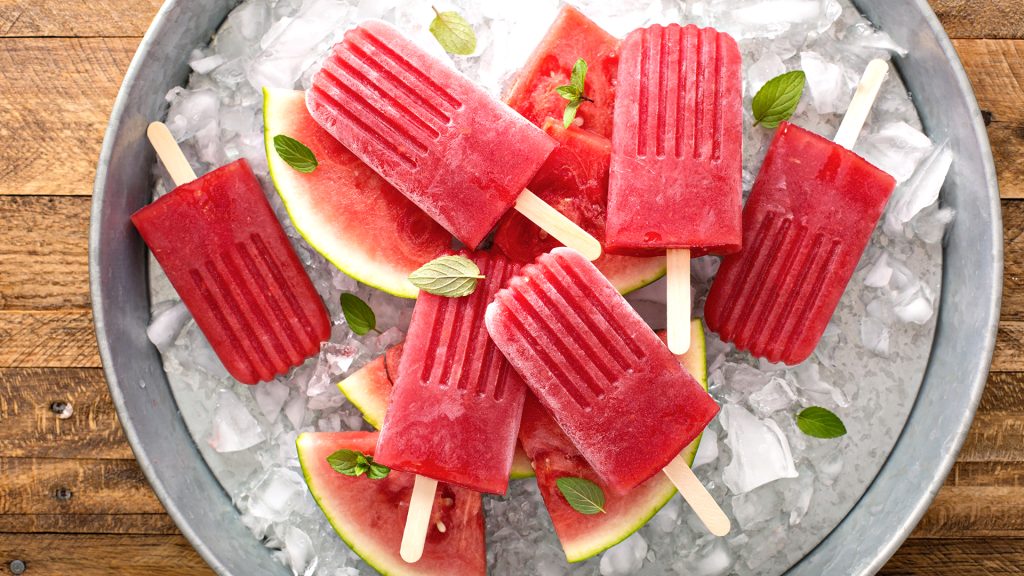 Watermelon mojito popsicles on ice filled tray
