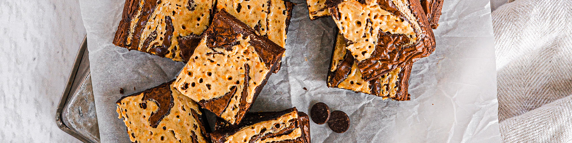 Top view of Sriracha Chocolate and Tahini Brownies cut and placed on top of parchment paper.