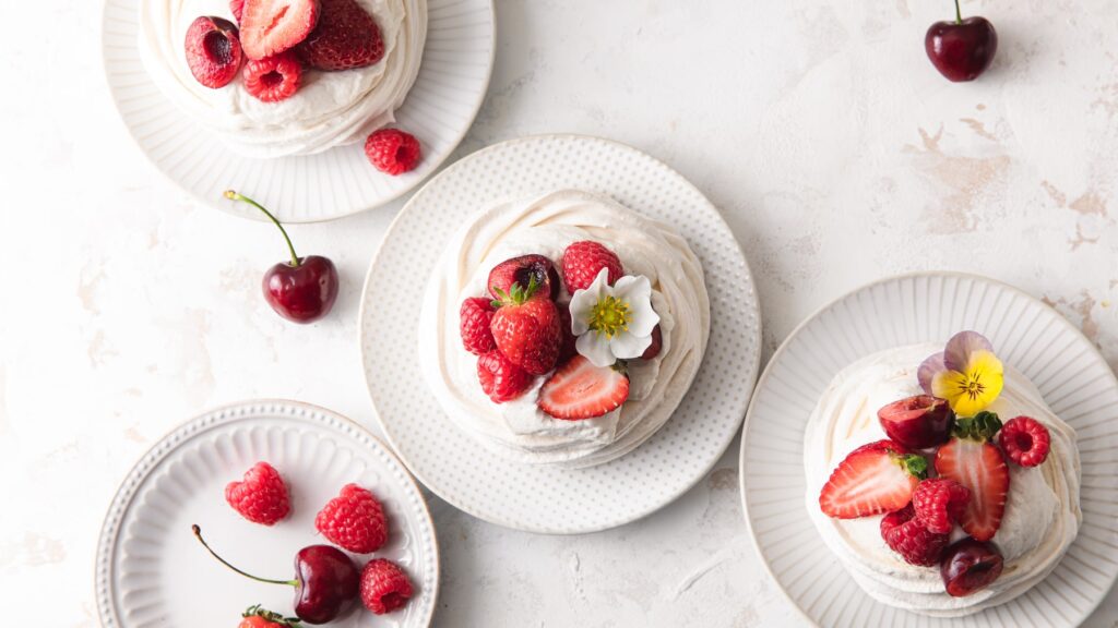 Mini vanilla bean pavlova with whipped cream and berries