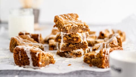Chewy Vanilla Blondies stacked in pile on neutral background
