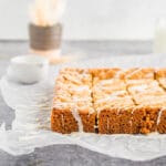 Side profile of Chewy Vanilla Blondies sliced on neutral background