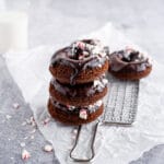 Chocolate donuts with chocolate glaze and crushed peppermint candies on cooling rack