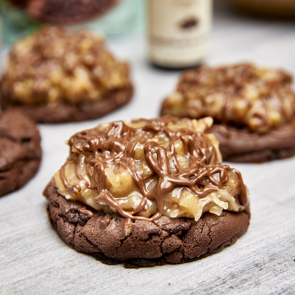 Chocolate cookies with German Chocolate Frosting and Ganache on neutral background