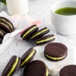 Matcha filled cocoa cookies on neutral background