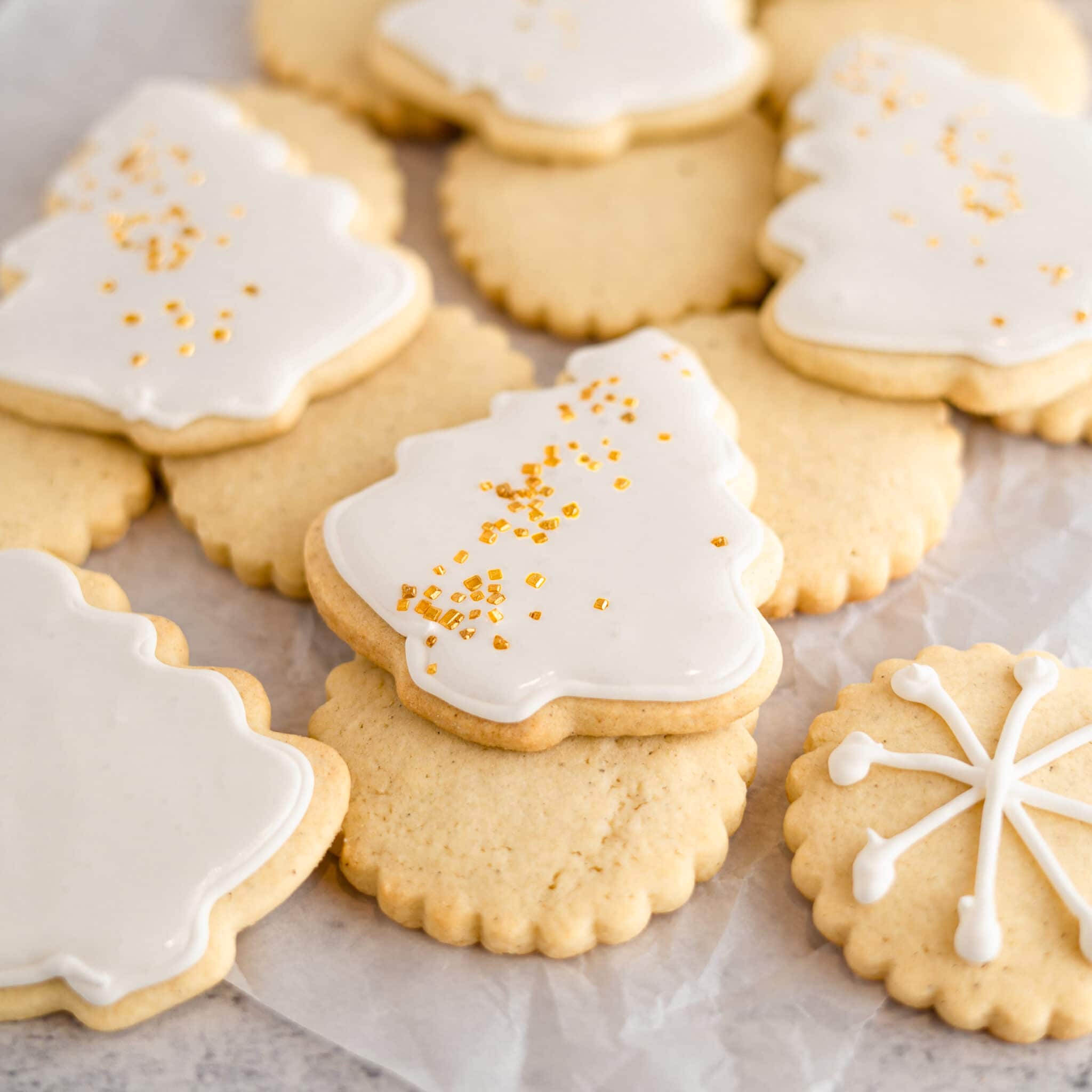 Soft vanilla sugar cookie with white royal icing on neutral background