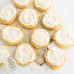Overhead shot of several Cornbread cookies with honey frosting placed on a neutral background