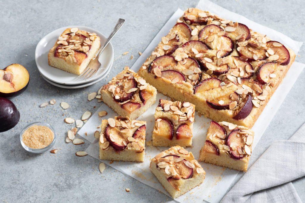 Vanilla plum cake with vanilla paste and plums around