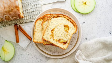 Swirly apple bread cut on a decorative backdrop