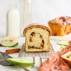 Swirly apple bread cut on a decorative backdrop