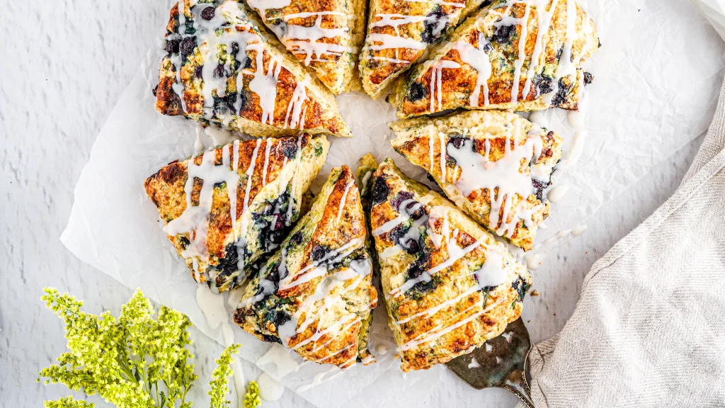 Top shot of Creamy Lemon Blueberry Scones with Vanilla Bean Glazed drizzled on top.