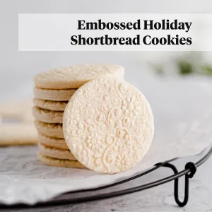 embossed shortbread cookies on a cooling rack with parchment paper
