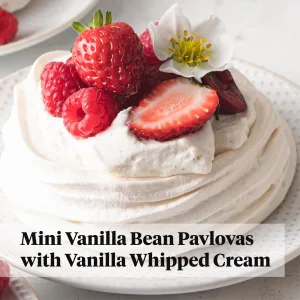 Airy pavlova with whipped cream and strawberries and raspberries