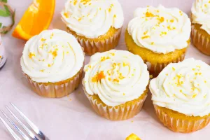 close up top angle shot of fiori di sicilia cupcakes with orange zest for garnish