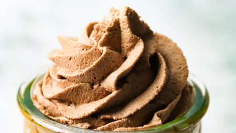 Close up of cocoa whipped cream piped in a jar.