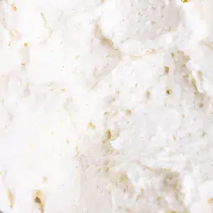 close up of whipped cream containing flecks of vanilla seeds.
