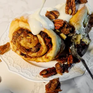 pecan fig lemon sticky bun with pecans on plate