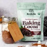 Side portrait of diy hot cocoa mix with a kraft paper tag held onto the jar by twine. Next to the jar is Rodelle's 8oz Organic cocoa bag.