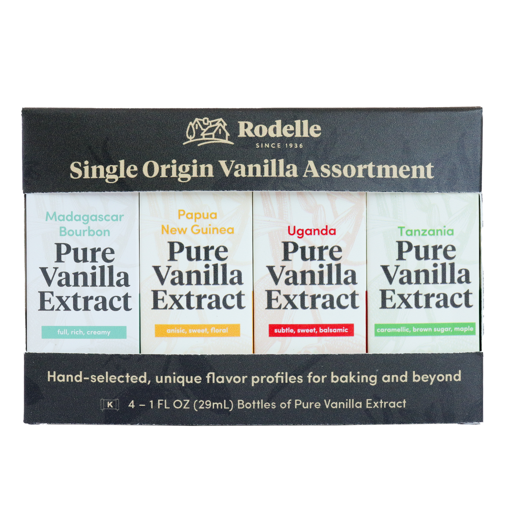 Front image of Rodelle's single origin gift pack in gray/brown packaging and an open window showing all four pure vanilla extracts in package including madagascar bourbon, papua new guinea, uganda, and tanzania