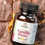 close up photo of Rodelle's 2oz natural vanilla paste sitting on top of vanilla chocolate date bark sprinkled with flaky sea salt.