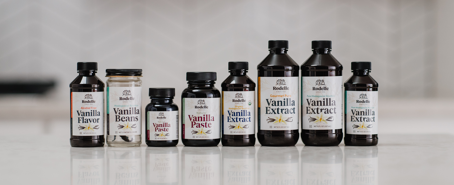 bottles of Rodelle pure vanilla extract on grey counter and grey tile in background